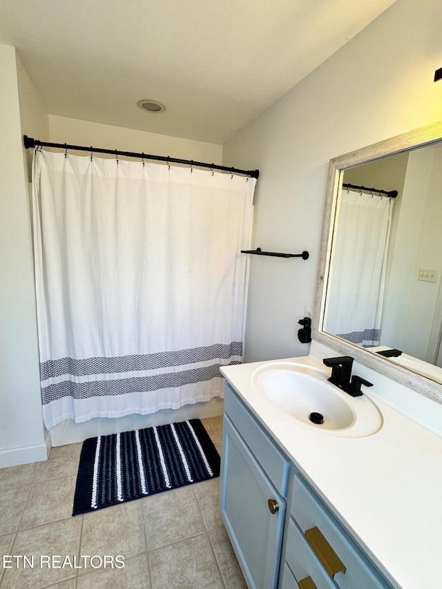 bathroom with tile patterned flooring and vanity