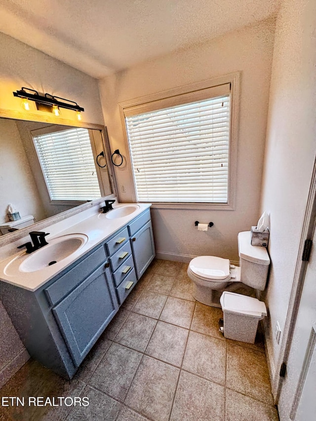 bathroom with vanity, toilet, and tile patterned flooring