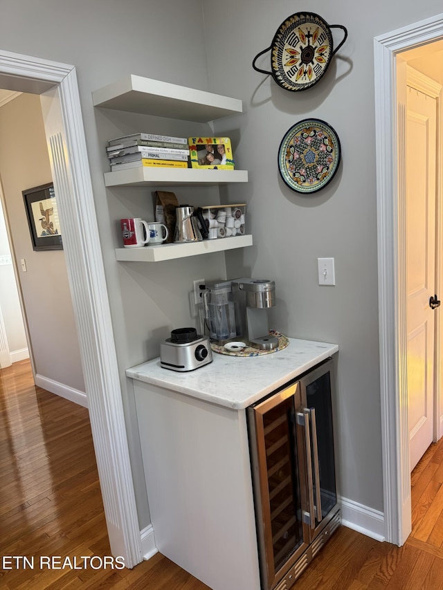 bar with wine cooler and hardwood / wood-style flooring