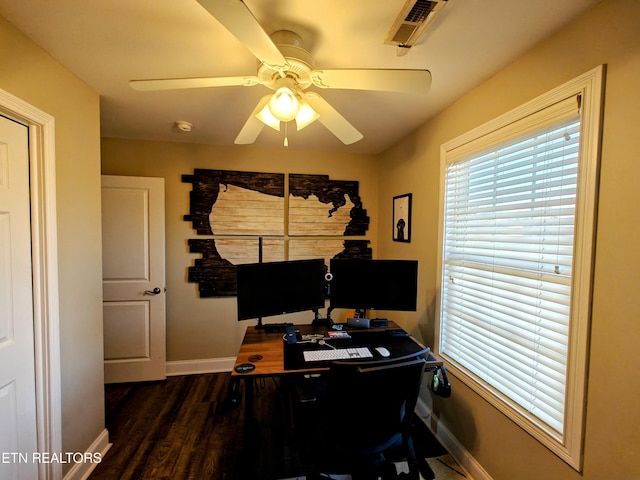 home office with dark hardwood / wood-style flooring and ceiling fan