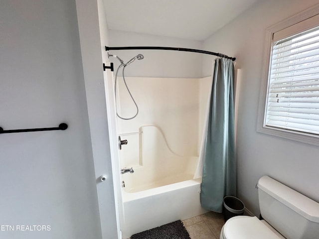 bathroom featuring tile patterned floors, toilet, and shower / bath combo