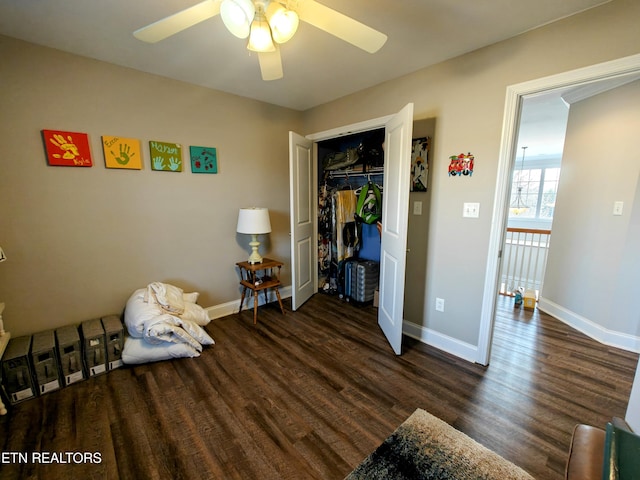 bedroom with dark wood-type flooring, a closet, and ceiling fan