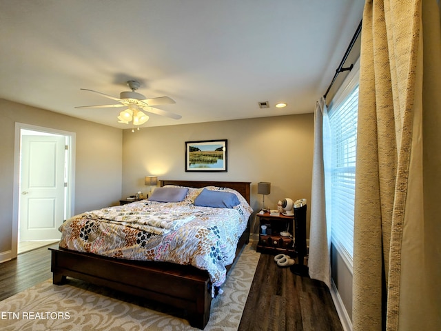 bedroom with ceiling fan and dark hardwood / wood-style flooring