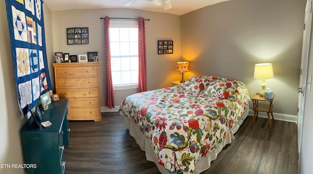 bedroom with dark hardwood / wood-style floors