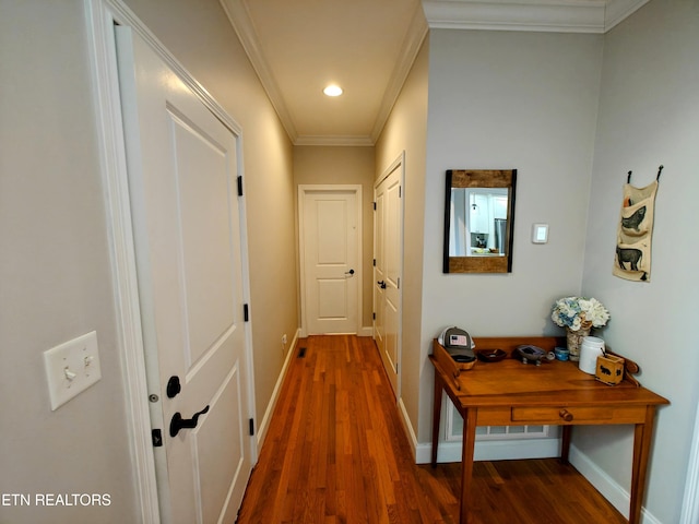 hallway with crown molding and dark wood-type flooring