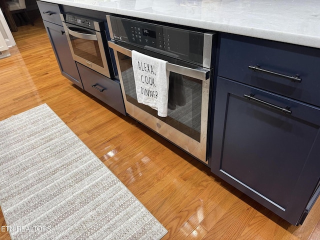 interior details with oven and light wood-type flooring