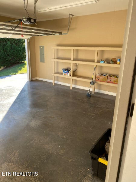 garage featuring a garage door opener and electric panel