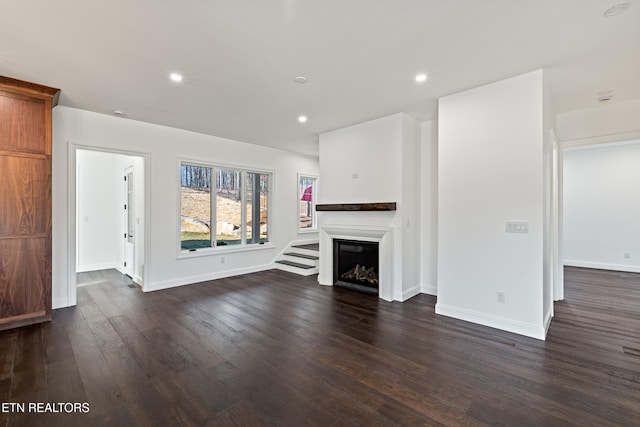 unfurnished living room featuring dark wood-type flooring