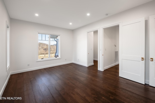 unfurnished bedroom featuring dark hardwood / wood-style flooring