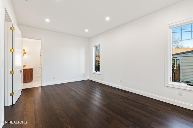 empty room with dark hardwood / wood-style floors