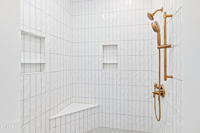 bathroom with a tile shower