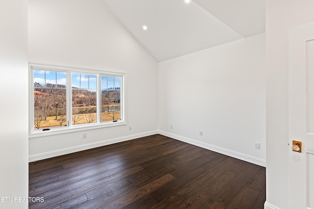 spare room featuring dark hardwood / wood-style floors and high vaulted ceiling