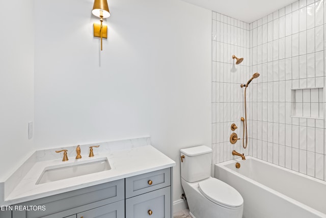 full bathroom with vanity, toilet, and tiled shower / bath combo