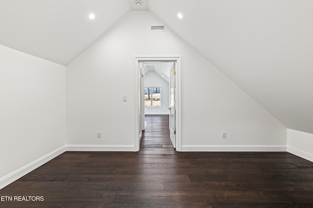 additional living space featuring lofted ceiling and dark hardwood / wood-style floors