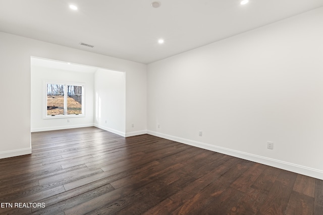 empty room with dark hardwood / wood-style floors