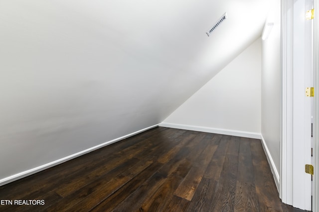 interior space with lofted ceiling and dark hardwood / wood-style floors