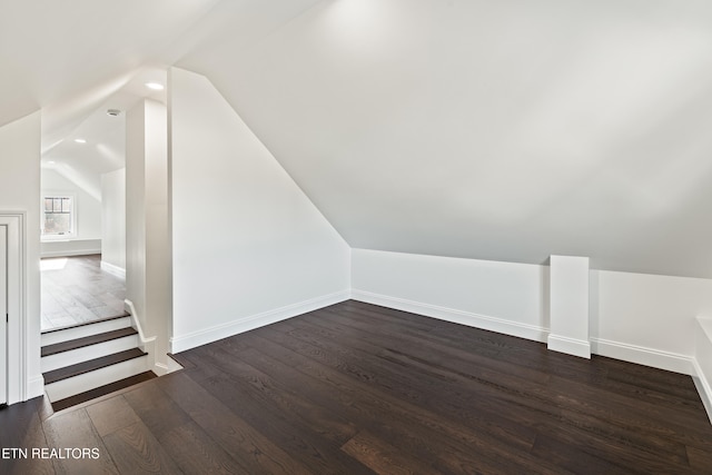 additional living space with lofted ceiling and dark hardwood / wood-style floors