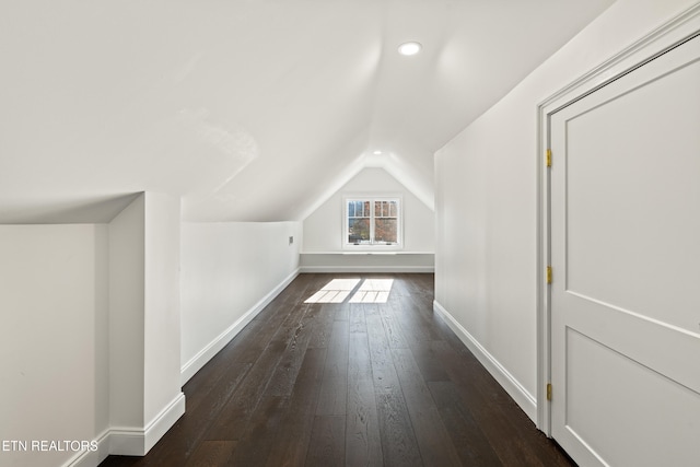 additional living space with lofted ceiling and dark hardwood / wood-style floors