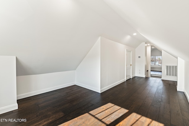 bonus room featuring dark hardwood / wood-style flooring and lofted ceiling