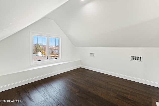 additional living space featuring lofted ceiling and hardwood / wood-style floors