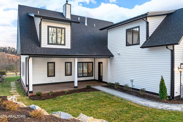 back of property featuring a lawn and a patio area