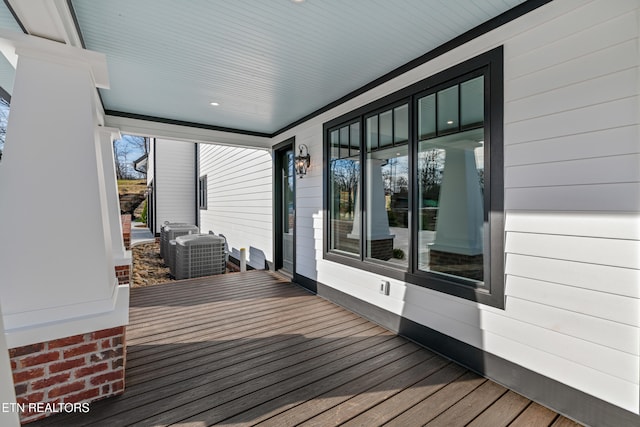 wooden deck featuring covered porch and central air condition unit