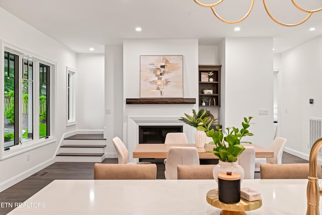 1521 Cherokee Blvd, Knoxville, TN 37919 - dining space featuring wood finished floors, baseboards, a glass covered fireplace, and recessed lighting