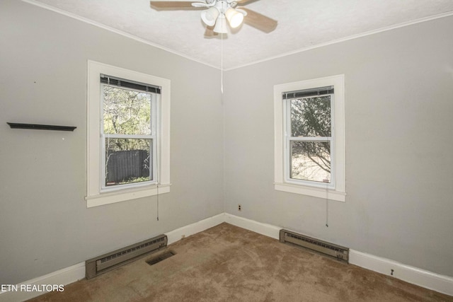 carpeted empty room with ceiling fan and a baseboard radiator