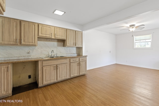 kitchen with ceiling fan, sink, light hardwood / wood-style flooring, and tasteful backsplash