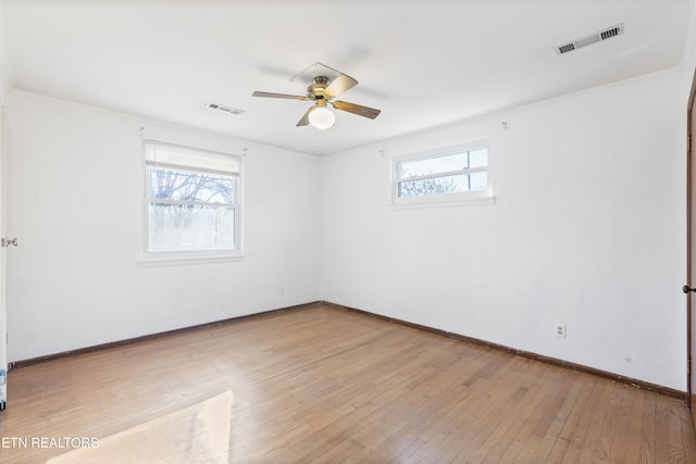 unfurnished room with ceiling fan, light hardwood / wood-style flooring, and a healthy amount of sunlight