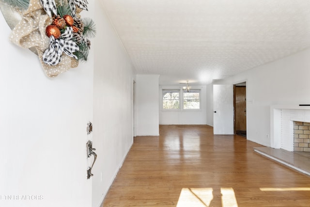 unfurnished living room featuring hardwood / wood-style flooring and an inviting chandelier