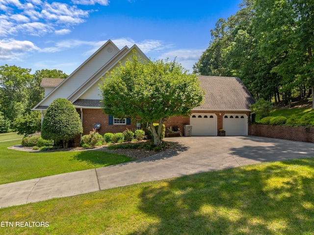 view of front of property featuring a front yard and a garage