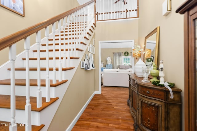 staircase with hardwood / wood-style flooring