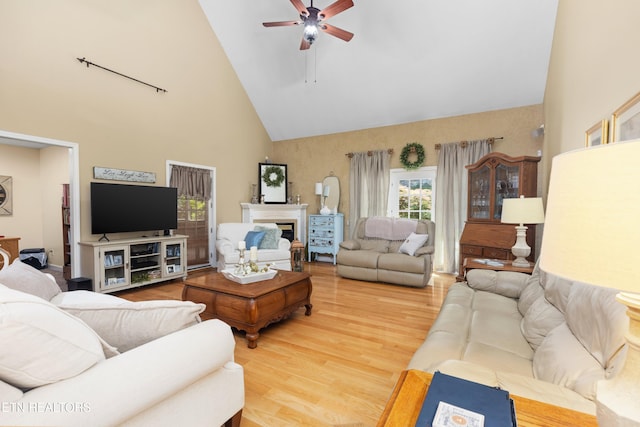 living room with high vaulted ceiling, ceiling fan, and hardwood / wood-style flooring