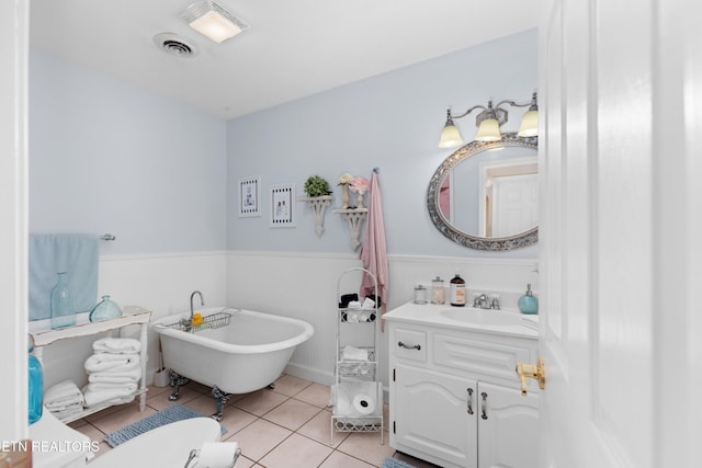 bathroom featuring tile patterned floors, a bathtub, and vanity