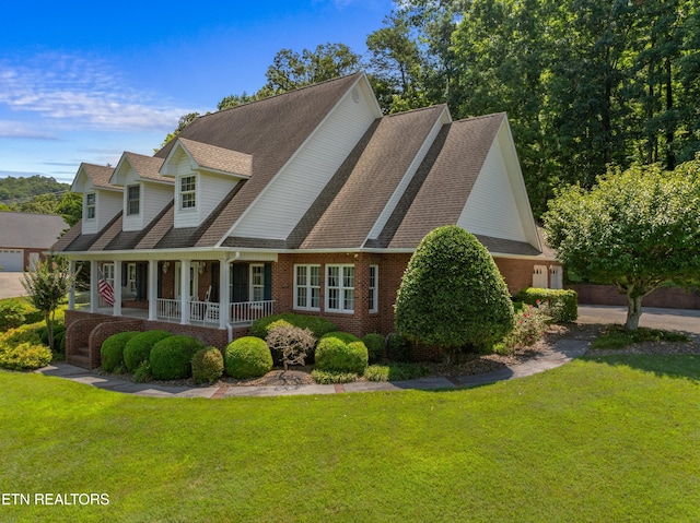 exterior space featuring covered porch and a front yard