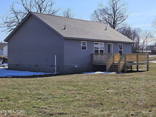 rear view of property featuring a deck and a yard