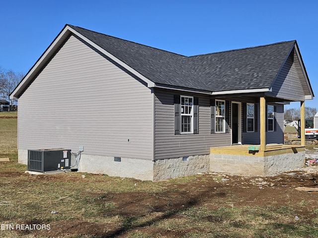 view of side of property featuring central AC unit and covered porch