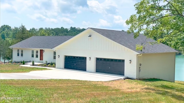 view of front of house featuring a garage and a front lawn