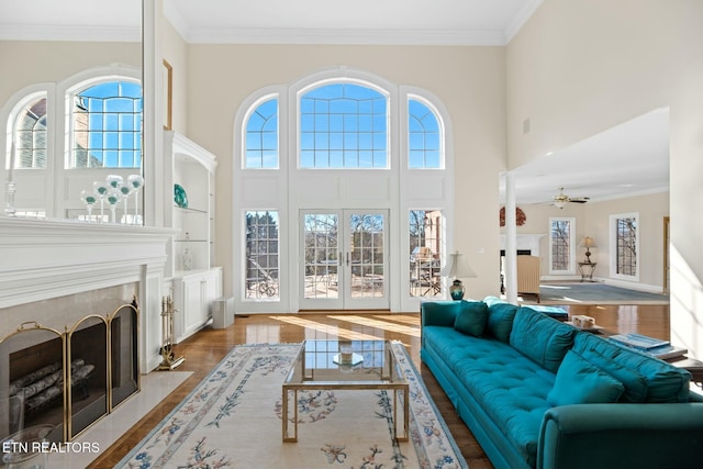 living room featuring a wealth of natural light, light hardwood / wood-style flooring, and ornamental molding