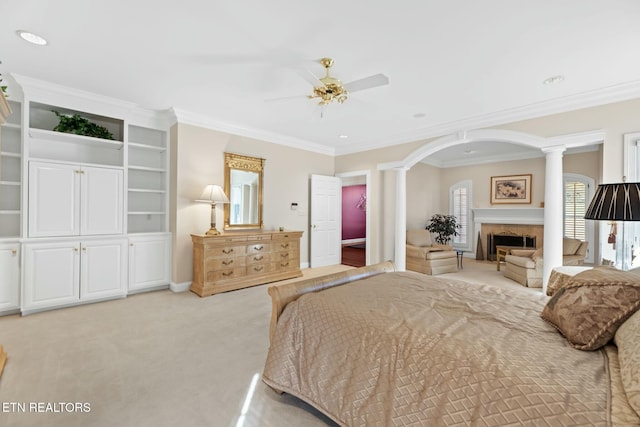 bedroom with light carpet, ornamental molding, decorative columns, and ceiling fan