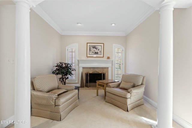 sitting room with plenty of natural light, a tile fireplace, and ornate columns