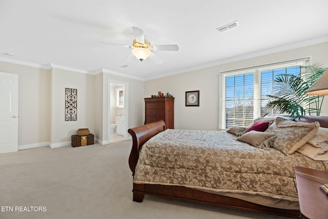 carpeted bedroom featuring ensuite bath, ornamental molding, and ceiling fan