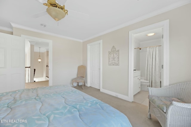 carpeted bedroom with ornamental molding, ensuite bathroom, and ceiling fan