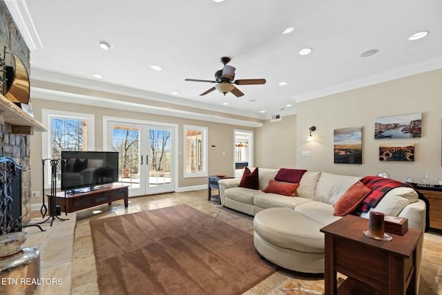 tiled living room featuring crown molding, a fireplace, and french doors