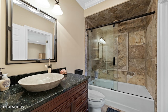 full bathroom featuring enclosed tub / shower combo, ornamental molding, vanity, and toilet