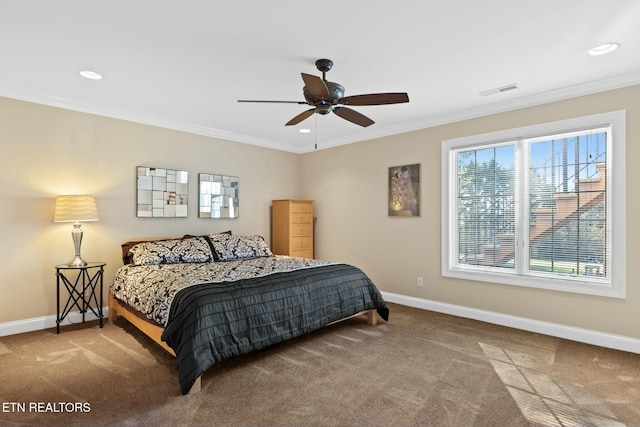 carpeted bedroom featuring ornamental molding and ceiling fan