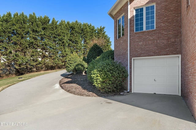 view of side of home featuring a garage