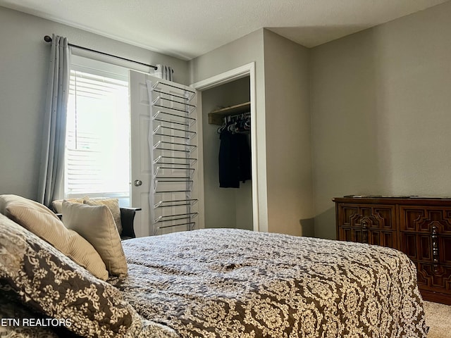 carpeted bedroom featuring a closet and a textured ceiling