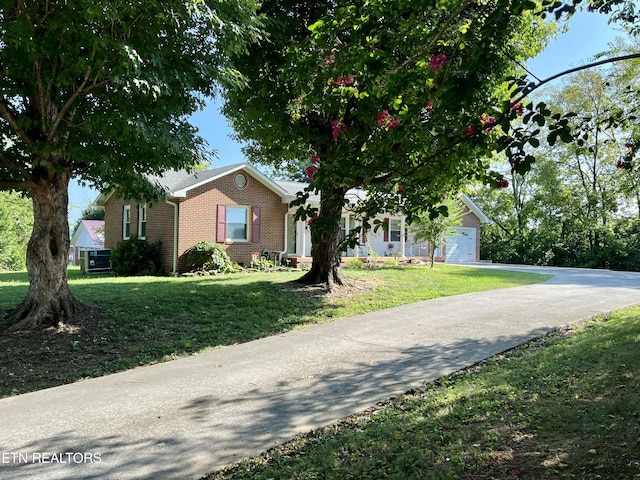 view of front of house with a garage and a front lawn